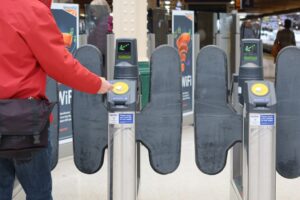 Person passing through ticket gates at a London railway station