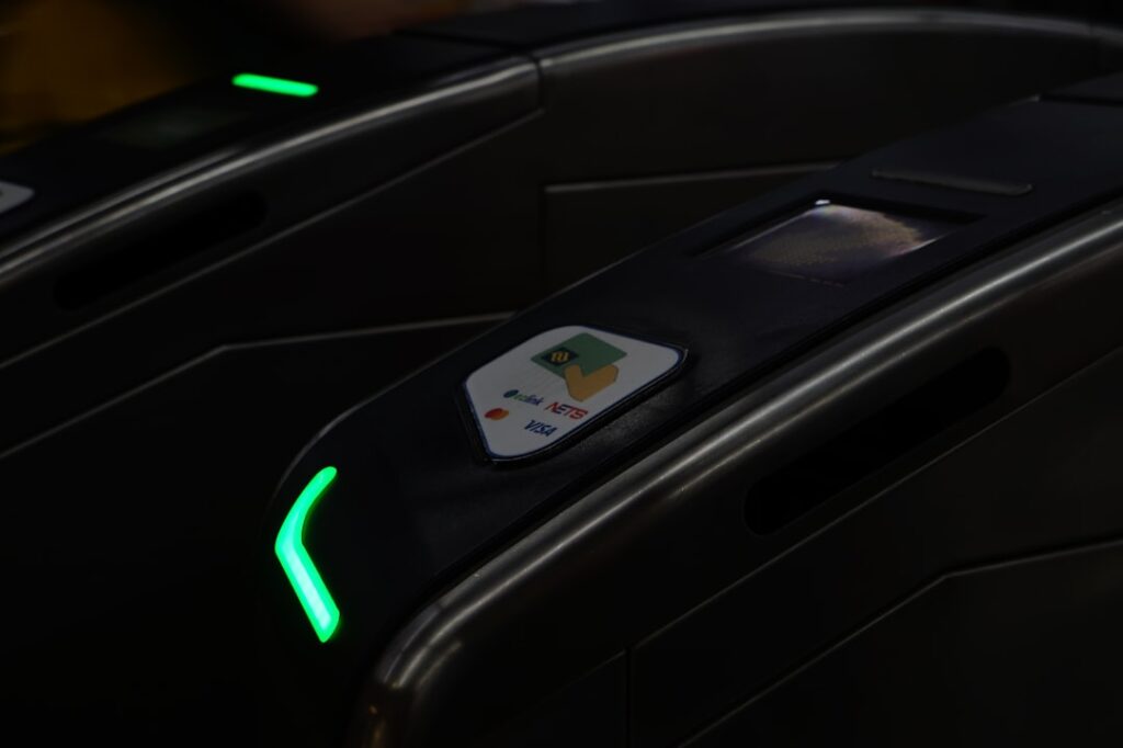 A mass rapid transit (MRT) gate that accepts contactless cards, digital wallets, EZ-Link cards and NETS cards.