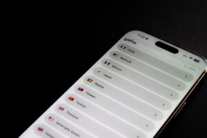 Modern smartphone displaying an eSIM service provider application with multiple country options for international connectivity. The clean interface shows various destinations including Italy, Malaysia, Mexico, Japan, Spain, Taiwan, Turkey, Thailand, and the United States, each represented with their respective flags. The Dutch language interface suggests this mobile virtual network service caters to European travelers seeking seamless international roaming solutions. Perfect for illustrating modern telecommunications technology, digital nomad lifestyle, international business or travel.