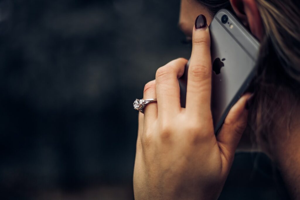 An Engagement Ring Next To An iPhone 6s