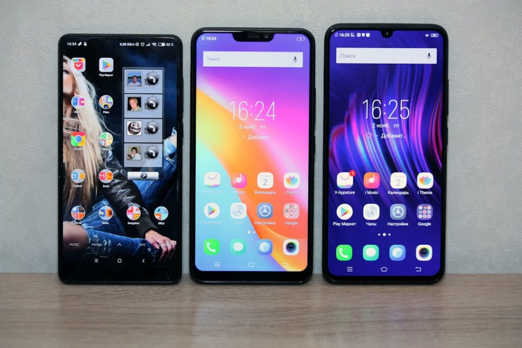 Thre different smartphones with colourful displays.