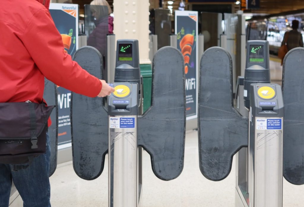 Person passing through ticket gates at a London railway station